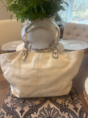 Coach Cream Perforated Signature Tote with Leather Handles.